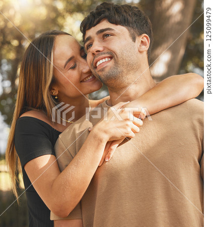 Couple, love and happy outdoor, hug and smile for a relationship, care and romantic date in summer. Girlfriend and boyfriend hugging with care for anniversary or happiness together in a nature park 125099479