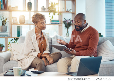 Finance, mortgage and black couple in debt planning a budget, savings or insurance payments at home. Mature, inflation and married black woman talking to an African angry partner about money problems 125099490