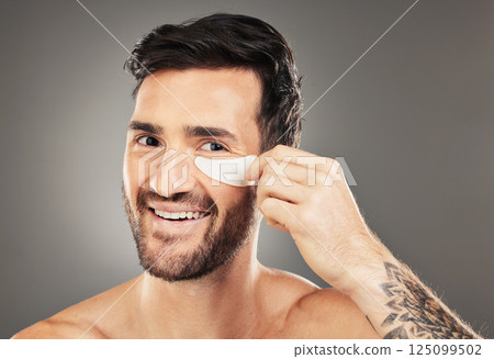 Man, eye patch and product for skincare, beauty and health with a smile for cosmetic, collagen and dermatology. Male, happy and face portrait with young model advertising healthy skin and wellness 125099502