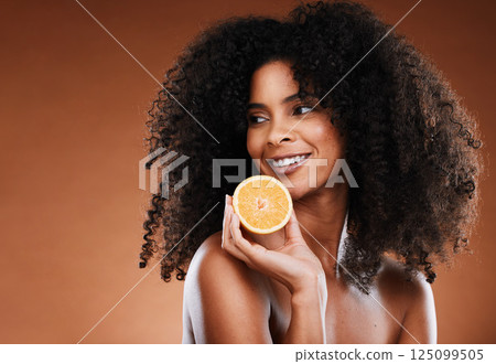Black woman, fruit and natural beauty with an orange for skincare, health and glowing skin on a brown background. Cosmetic, vitamin c and citrus for organic facial treatment product and skin care 125099505