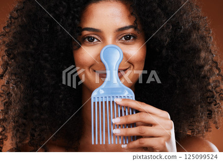 Black woman face, beauty and comb for hair care, beauty and afro with smile for happy smile in studio background. Portrait of African American female smiling for beauty hairstyle or salon treatment Black woman face, beauty and comb for hair care, beauty and afro with smile for happy smile in studio background. Portrait of African American female smiling for beauty hairstyle or salon treatment 125099524