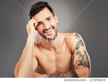 Man, beauty and sexy with body, tattoo and happy portrait against grey studio background with mockup space. Male model, sexy and smile for self care, skincare and cosmetic wellness with clean face Man, beauty and sexy with body, tattoo and happy portrait against grey studio background with mockup space. Male model, sexy and smile for self care, skincare and cosmetic wellness with clean face 125099629