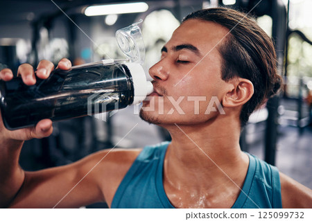 Drinking water, fitness and gym man with challenge workout training for muscle, power and energy with motivation, goals and sweating. Tired sports, athlete person with water bottle in health exercise 125099732
