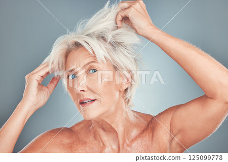 Senior woman, messy hair and stress for salon care, cosmetics or cut against a grey studio background. Portrait of elderly female having a bad hair day looking for makeover or cosmetic treatment Senior woman, messy hair and stress for salon care, cosmetics or cut against a grey studio background. Portrait of elderly female having a bad hair day looking for makeover or cosmetic treatment 125099778