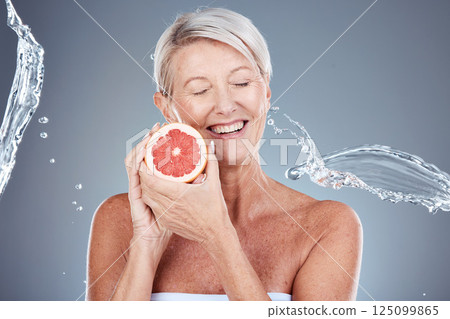 Wellness, beauty and grapefruit woman with water splash for body care, skincare and health cosmetics marketing. Clean, happy and healthy senior model for cosmetic advertising on gray studio mockup. Wellness, beauty and grapefruit woman with water splash for body care, skincare and health cosmetics marketing. Clean, happy and healthy senior model for cosmetic advertising on gray studio mockup. 125099865