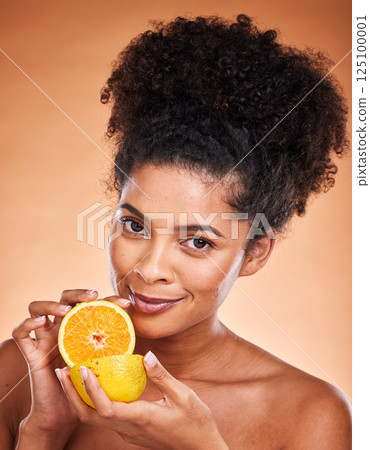 Lemon, skincare and black woman with food to detox against a brown studio background. Marketing, vitamin c and portrait of an African model advertising fruit for natural beauty, skin and nutrition Lemon, skincare and black woman with food to detox against a brown studio background. Marketing, vitamin c and portrait of an African model advertising fruit for natural beauty, skin and nutrition 125100001