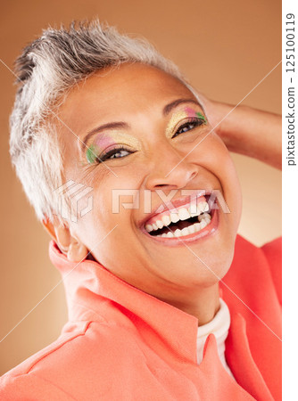 Beauty, senior woman and makeup with face, smile and happy with color cosmetics against background. Elderly model, happiness and portrait with skincare, wellness and skin health with facial cosmetics 125100119