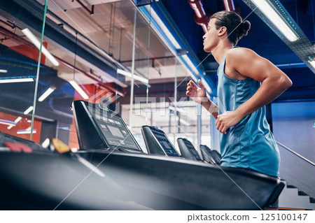 Fitness, man and running on treadmill for workout, exercise or cardio training for endurance at the gym. Active male runner in sports wellness having a run on stationary equipment at the health club Fitness, man and running on treadmill for workout, exercise or cardio training for endurance at the gym. Active male runner in sports wellness having a run on stationary equipment at the health club 125100147
