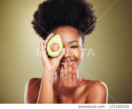 Black woman, laughing or avocado skincare on green studio background for healthcare diet, dermatology wellness or nutrition. Portrait, smile or happy beauty model with fruit as organic facial product Black woman, laughing or avocado skincare on green studio background for healthcare diet, dermatology wellness or nutrition. Portrait, smile or happy beauty model with fruit as organic facial product 125100209
