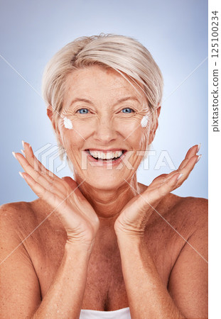 Beauty, portrait of mature woman and cream for skincare, anti aging and wellness on a grey studio background. Skin care, moisturiser or lotion with a senior female apply suncream or spf on her face Beauty, portrait of mature woman and cream for skincare, anti aging and wellness on a grey studio background. Skin care, moisturiser or lotion with a senior female apply suncream or spf on her face 125100234