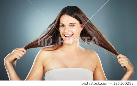 Hair care, beauty and woman with hair in hands for growth on gray background studio. Hair salon, spa and portrait of girl with long, healthy and natural style after treatment, products and cosmetics Hair care, beauty and woman with hair in hands for growth on gray background studio. Hair salon, spa and portrait of girl with long, healthy and natural style after treatment, products and cosmetics 125100292