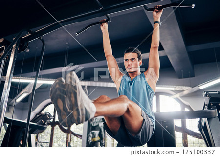 Fitness, exercise and weight training with a man at gym for a workout for focus and strong body and mindset for health and wellness. Bodybuilder or athlete using pull up bar for power and muscle Fitness, exercise and weight training with a man at gym for a workout for focus and strong body and mindset for health and wellness. Bodybuilder or athlete using pull up bar for power and muscle 125100337