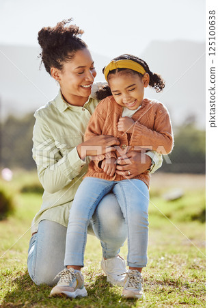 Love, family and mother and girl in a park, laugh and embrace while play, relax and having fun in nature. Happy family, mom and child enjoy quality time, game and playful in a forest in brazil 125100638