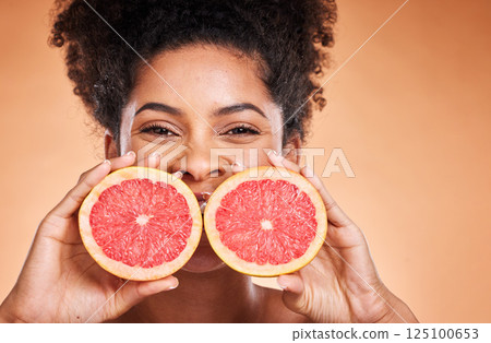 Grapefruit, black woman and vitamin c beauty, skincare and wellness, healthy body and aesthetics, natural cosmetics and face on studio background. Portrait of african model, citrus nutrition and diet Grapefruit, black woman and vitamin c beauty, skincare and wellness, healthy body and aesthetics, natural cosmetics and face on studio background. Portrait of african model, citrus nutrition and diet 125100653
