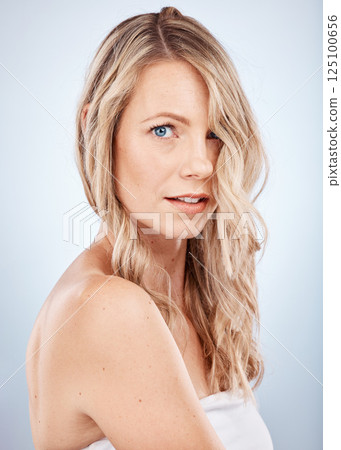 Portrait, cosmetics and young woman with skincare, hair and natural beauty with grey studio background. Confident, makeup and healthy girl with organic facial, wellness and smooth skin for body care 125100656