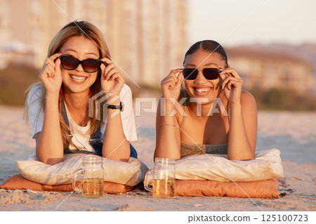Beach, happy and friends relaxing with sunglasses while on a summer vacation together in Mauritius. Freedom, travel and women on a tropical holiday, adventure or journey in nature by the ocean or sea 125100723