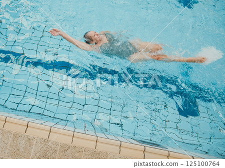 Senior woman, swimming pool and happy retirement, healthy lifestyle or wellness sport in summer outdoor. Old woman doing backstroke in water for activity, hobby and relax on holiday, vacation and sun Senior woman, swimming pool and happy retirement, healthy lifestyle or wellness sport in summer outdoor. Old woman doing backstroke in water for activity, hobby and relax on holiday, vacation and sun 125100764
