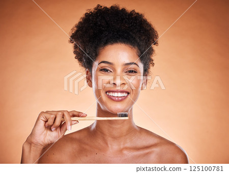 Dental care, toothbrush and hygiene with a model black woman brushing her teeth in studio on a beige background. Portrait, face and oral treatment with an attractive young female proud of her routine Dental care, toothbrush and hygiene with a model black woman brushing her teeth in studio on a beige background. Portrait, face and oral treatment with an attractive young female proud of her routine 125100781