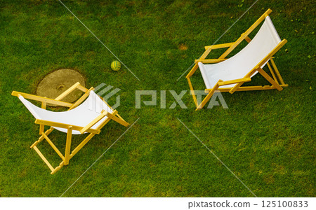 Deck chairs in garden 125100833