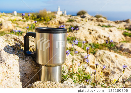 Thermal mug, thermos on nature. Travel outdoor picnic. 125100896