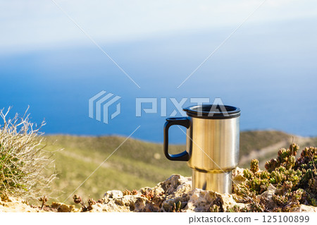 Thermal mug, thermos on nature. Travel outdoor picnic. Thermal mug, thermos on nature. Travel outdoor picnic. 125100899