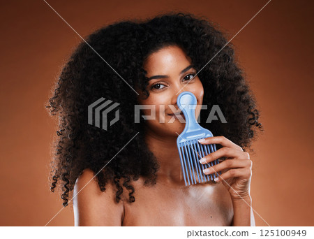Curly hair comb, beauty and black woman with afro hairstyle, cosmetics and perm on studio background. Portrait happy young african girl, hair brush and natural hair care, fashion and funky hair style Curly hair comb, beauty and black woman with afro hairstyle, cosmetics and perm on studio background. Portrait happy young african girl, hair brush and natural hair care, fashion and funky hair style 125100949
