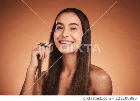 Cosmetics, hair care and young woman pride with natural beauty, healthy and confident with brown studio background. Portrait, makeup and girl playing with hair, wellness and organic for happiness. 125100980