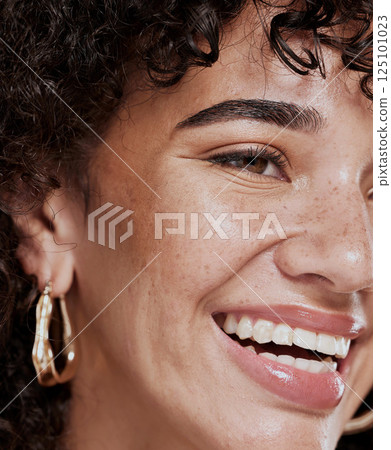 Face, beauty and smile with a model black woman in studio for skincare, cosmetics or natural treatment. Wellness, makeup and luxury with an attractive young female closeup for facial dermatology 125101023