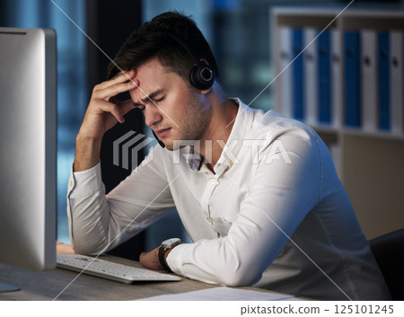 Stress, call center and customer service with a man consultant suffering with burnout while working late at night. Crm, ecommerce and compliance with a male employee working in retail or sales Stress, call center and customer service with a man consultant suffering with burnout while working late at night. Crm, ecommerce and compliance with a male employee working in retail or sales 125101245