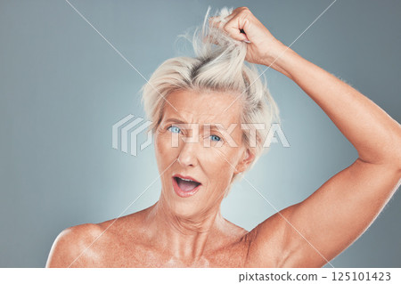 Senior, woman and hair with wow face in studio for cosmetics, beauty and wellness against blue background. Elderly model, surprised and hair care with makeup, cosmetic and hairstyle against backdrop 125101423