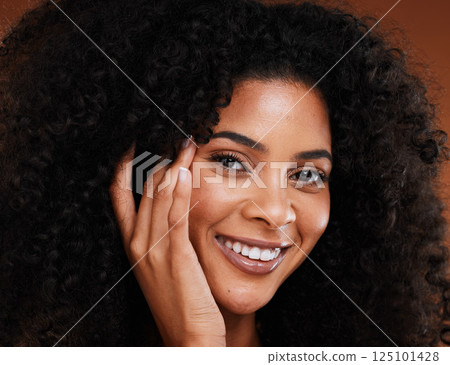 Face, beauty and skincare with a model black woman in studio on a brown background with afro hair. Portrait, haircare and cosmetics with an attractive young female posing to promote treatment Face, beauty and skincare with a model black woman in studio on a brown background with afro hair. Portrait, haircare and cosmetics with an attractive young female posing to promote treatment 125101428
