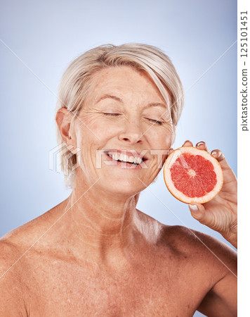 Grapefruit, skincare and senior woman with food for beauty, aging and wellness against a grey studio background. Smile, healthy and excited elderly model with a fruit with nutrition for body Grapefruit, skincare and senior woman with food for beauty, aging and wellness against a grey studio background. Smile, healthy and excited elderly model with a fruit with nutrition for body 125101451