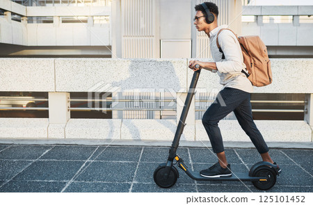 City, travel and black man with eco scooter for net zero and eco friendly work commute in urban town. Environmental, carbon neutral and worker transportation with music or podcast on electric bike. City, travel and black man with eco scooter for net zero and eco friendly work commute in urban town. Environmental, carbon neutral and worker transportation with music or podcast on electric bike. 125101452