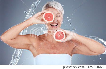 Grapefruit, water and senior woman with a splash for skincare, beauty and wellness against a grey studio background. Water splash, health and excited elderly model with fruit for diet lifestyle Grapefruit, water and senior woman with a splash for skincare, beauty and wellness against a grey studio background. Water splash, health and excited elderly model with fruit for diet lifestyle 125101663