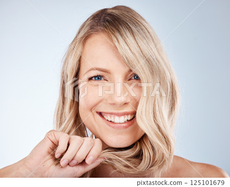 Face, beauty and hair with a model woman in studio on a gray background for natural haircare treatment. Skincare, cosmetics and hairstyle with an attractive young female posing to promote keratin 125101679