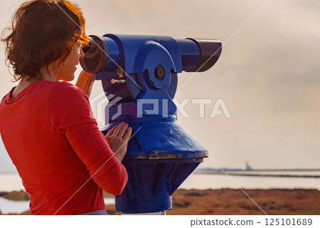 Woman using tourist binoculars, Cabo de Gata, Spain Woman using tourist binoculars, Cabo de Gata, Spain 125101689