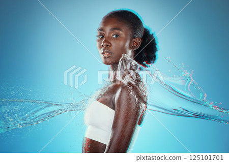 Skincare, water and black woman with a splash for hydration, cleaning and beauty against a blue studio background. Spa, wellness and African model with peace, calm and relax from liquid bodycare Skincare, water and black woman with a splash for hydration, cleaning and beauty against a blue studio background. Spa, wellness and African model with peace, calm and relax from liquid bodycare 125101701