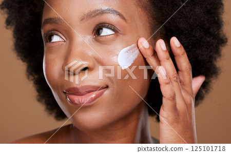 Black woman, face cream and beauty, sunscreen makeup product and luxury facial treatment on studio background. Young african model, body lotion and cosmetics for healthy skincare, wellness and shine Black woman, face cream and beauty, sunscreen makeup product and luxury facial treatment on studio background. Young african model, body lotion and cosmetics for healthy skincare, wellness and shine 125101718
