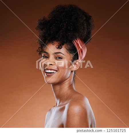 Hair care, skincare and black woman with a smile for beauty against a brown studio background. Wellness, happy and portrait of an African girl model with makeup, cosmetics and routine grooming 125101725