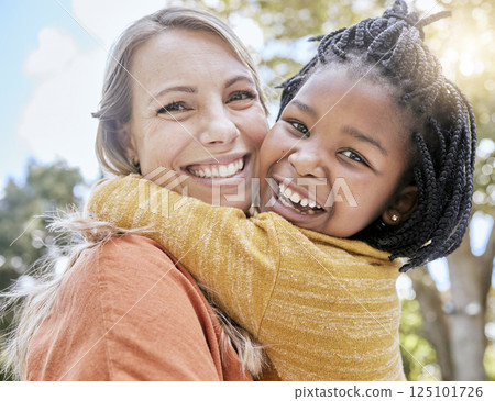 Mom, child and interracial hug in park with smile, trees and sunshine in summer together for bonding. Mother, happy black child and outdoor embrace with love, care and diversity for happy family 125101726