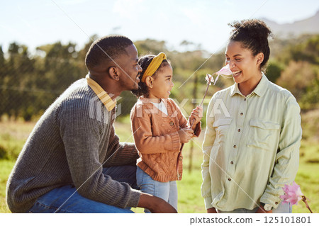 Happy family, countryside fun and child with flower tickle moms nose, play or enjoy outdoor quality time together. Love, nature freedom and spring peace for kid girl, parents or bonding black family 125101801