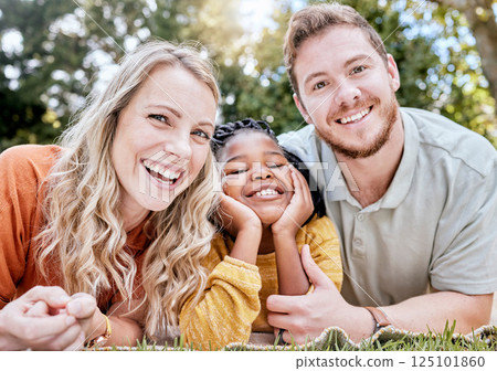 Adoption, mother and father in nature as a happy family relaxing on a picnic bonding in summer holidays. Interracial, portrait and healthy mom with dad enjoying a lovely vacation with a girl child Adoption, mother and father in nature as a happy family relaxing on a picnic bonding in summer holidays. Interracial, portrait and healthy mom with dad enjoying a lovely vacation with a girl child 125101860