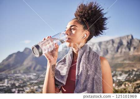 Fitness, wellness and black woman drinking water in nature after workout, exercise and run. Health, hydration and girl drink mineral liquid from bottle after marathon training, exercising and running 125101969