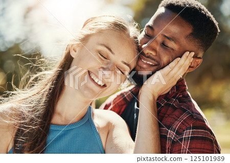 Park, love and interracial young couple enjoying weekend, holiday and summer vacation together. Bonding, affection and happy black man and white woman embrace, hugging and smiling outdoors in nature 125101989