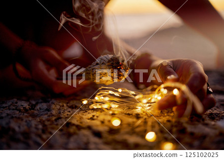 Hands, meditation with zen and burning sage for cleanse, spiritual and light for healing and balance outdoor closeup. Mindfulness, positive energy and ritual for wellness and health with aromatherapy 125102025