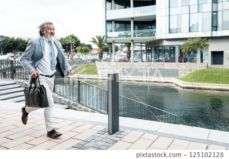 Businessman, running and work time in the city for urgent meeting, deadline or behind schedule. Elderly man having a run to the office for business deal, appointment or opportunity in the outdoors 125102128