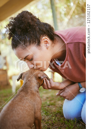 Kiss, dog and adoption with a black woman at a rescue shelter looking for a foster animal to love or care for. Kissing, love and pet with a young female adopting a puppy from a shelter to rehome Kiss, dog and adoption with a black woman at a rescue shelter looking for a foster animal to love or care for. Kissing, love and pet with a young female adopting a puppy from a shelter to rehome 125102137
