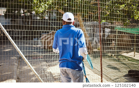 Volunteer, charity and animal shelter with a black man working at a rescue center for the adoption of foster pets. Worker, community and care with a male employee at work alone with rescue animals Volunteer, charity and animal shelter with a black man working at a rescue center for the adoption of foster pets. Worker, community and care with a male employee at work alone with rescue animals 125102140
