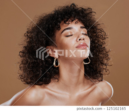 Beauty, skincare and portrait of elegant black woman model with cosmetics and afro hair style. Makeup, cosmetic glamour and a luxury skin care with beautiful face of African girl on studio background 125102165