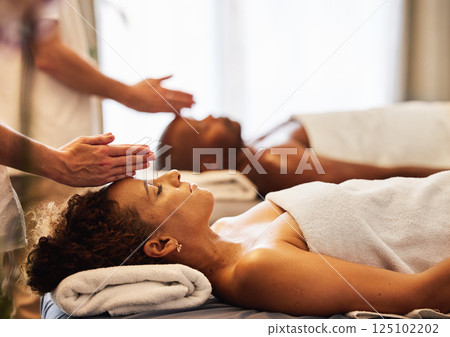 Black couple, head massage and luxury spa to relax in a room for health, wellness and physical therapy. Man and woman on table for skincare, body care and hospitality while on a vacation 125102202
